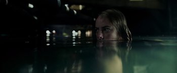 Movie still from “Crawl” (2019), directed by Alexandre Aja – A woman in the water looking at the camera; Close Up shot, Low angle