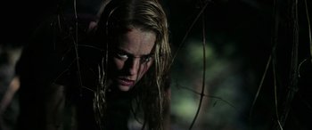 Movie still from “Crawl” (2019), directed by Alexandre Aja – A woman with blood on her face is looking at the camera; Close Up shot, Low angle