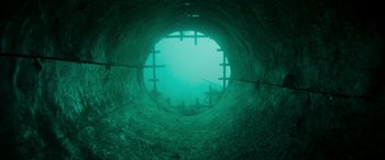 Movie still from “Crawl” (2019), directed by Alexandre Aja – A view from inside an underwater tunnel; Extreme Wide shot, Overhead angle