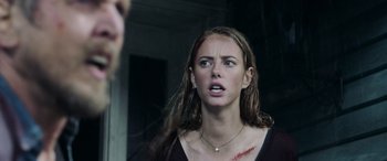 Movie still from “Crawl” (2019), directed by Alexandre Aja – A young woman with a blood stain on her face; Close Up shot, Over the shoulder angle