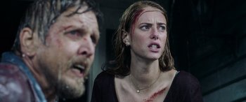 Movie still from “Crawl” (2019), directed by Alexandre Aja – A man and a woman with blood all over their face; Close Up shot, Low angle