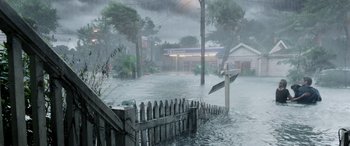 Movie still from “Crawl” (2019), directed by Alexandre Aja – A flooded area with a street sign and a wooden fence; Extreme Wide shot, High angle