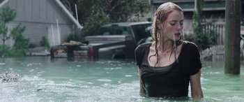 Movie still from “Crawl” (2019), directed by Alexandre Aja – A woman standing in a body of water; Medium shot, Over the shoulder angle