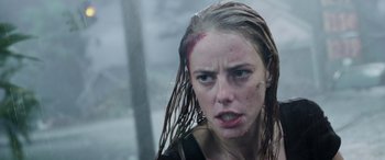 Movie still from “Crawl” (2019), directed by Alexandre Aja – A young woman with wet hair is looking at the camera; Close Up shot, Low angle