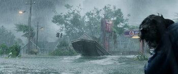 Movie still from “Crawl” (2019), directed by Alexandre Aja – A boat floating on top of a body of water; Extreme Wide shot, Low angle