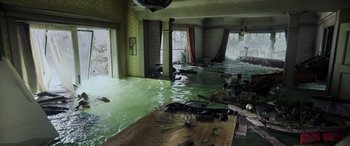 Movie still from “Crawl” (2019), directed by Alexandre Aja – A room flooded with water and debris on the floor; Extreme Wide shot, High angle