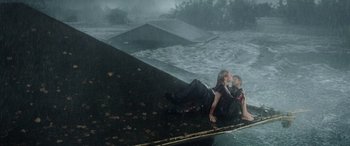 Movie still from “Crawl” (2019), directed by Alexandre Aja – A man and a woman sitting on the edge of a pool; Wide shot, Overhead angle