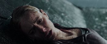 Movie still from “Crawl” (2019), directed by Alexandre Aja – A young man laying on the ground in the water; Close Up shot, Overhead angle