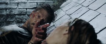 Movie still from “Crawl” (2019), directed by Alexandre Aja – A man with blood all over his face and head; Close Up shot, Over the shoulder angle