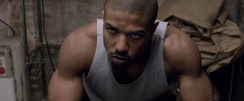 Movie still from “Creed” (2015), directed by Ryan Coogler – A person wearing a tank top; Close Up shot, High angle