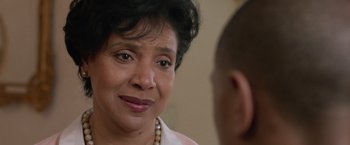 Movie still from “Creed” (2015), directed by Ryan Coogler – An older woman is looking at a younger man; Close Up shot, Over the shoulder angle
