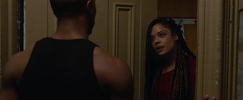 Movie still from “Creed” (2015), directed by Ryan Coogler – A man and a woman looking at each other in a mirror; Close Up shot, Over the shoulder angle
