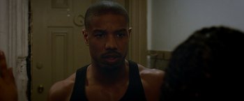 Movie still from “Creed” (2015), directed by Ryan Coogler – A person wearing a tank top; Close Up shot, Over the shoulder angle