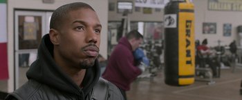 Movie still from “Creed” (2015), directed by Ryan Coogler – A person in a gym; Close Up shot, Over the shoulder angle