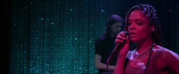 Movie still from “Creed” (2015), directed by Ryan Coogler – A person holding a microphone on a stage; Medium shot, High angle