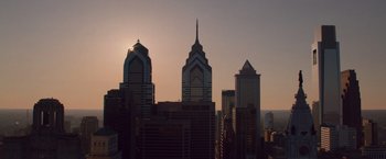 Movie still from “Creed” (2015), directed by Ryan Coogler – A view of the sun setting over a city skyline; Extreme Wide shot, High angle