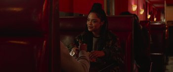 Movie still from “Creed” (2015), directed by Ryan Coogler – A woman sitting at a table in a restaurant; Close Up shot, Over the shoulder angle