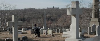 Movie still from “Creed” (2015), directed by Ryan Coogler – A man sitting on a chair in a cemetery; Extreme Wide shot, High angle