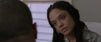Movie still from “Creed” (2015), directed by Ryan Coogler – A woman with braids looking into a mirror; Close Up shot, Over the shoulder angle