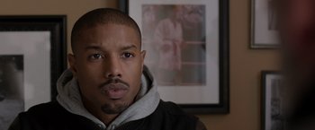 Movie still from “Creed” (2015), directed by Ryan Coogler – A person wearing a jacket; Close Up shot, Over the shoulder angle