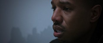 Movie still from “Creed” (2015), directed by Ryan Coogler – A man's face in a dark room; Close Up shot, High angle