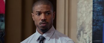 Movie still from “Creed” (2015), directed by Ryan Coogler – A person wearing a shirt and a tie; Close Up shot, Over the shoulder angle