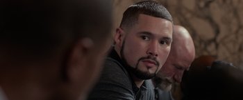 Movie still from “Creed” (2015), directed by Ryan Coogler – A person sitting in a room; Close Up shot, Over the shoulder angle