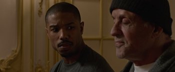 Movie still from “Creed” (2015), directed by Ryan Coogler – A man and a woman standing next to each other; Close Up shot, Over the shoulder angle