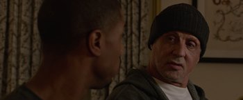 Movie still from “Creed” (2015), directed by Ryan Coogler – A man and a boy are talking to each other; Close Up shot, Over the shoulder angle