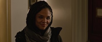 Movie still from “Creed” (2015), directed by Ryan Coogler – A young woman with braids wearing a black jacket; Close Up shot, Over the shoulder angle