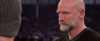 Movie still from “Creed” (2015), directed by Ryan Coogler – An older bald man with a beard looking to his left; Close Up shot, Low angle