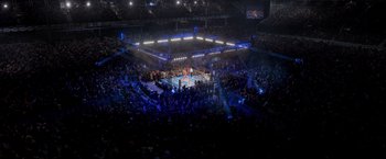 Movie still from “Creed” (2015), directed by Ryan Coogler – A boxing ring filled with people in the middle of a boxing ring; Extreme Wide shot, High angle