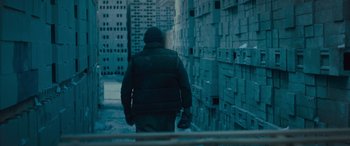 Movie still from “Creed II” (2018), directed by Steven Caple Jr. – A man walking down a street in the snow; Wide shot, Low angle