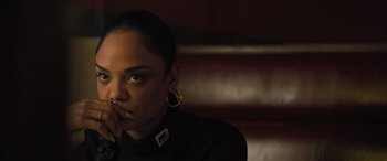 Movie still from “Creed II” (2018), directed by Steven Caple Jr. – A woman sitting in front of a wall with her hand on her face; Close Up shot, High angle