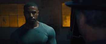 Movie still from “Creed II” (2018), directed by Steven Caple Jr. – A person wearing a shirt; Close Up shot, Low angle