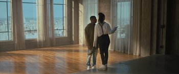 Movie still from “Creed II” (2018), directed by Steven Caple Jr. – A man and a woman standing next to each other in a room; Wide shot, Low angle