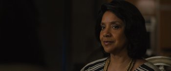 Movie still from “Creed II” (2018), directed by Steven Caple Jr. – A person wearing a necklace; Close Up shot, Over the shoulder angle