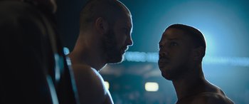 Movie still from “Creed II” (2018), directed by Steven Caple Jr. – Two men facing each other in a boxing ring; Close Up shot, Low angle