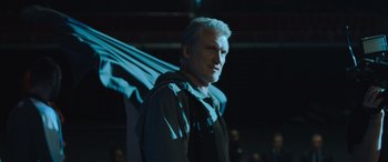 Movie still from “Creed II” (2018), directed by Steven Caple Jr. – A man standing in the dark with a light behind him; Medium shot, Low angle