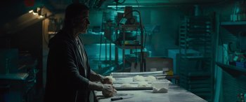 Movie still from “Creed II” (2018), directed by Steven Caple Jr. – A person in a kitchen preparing food on top of a table; Medium shot, Low angle