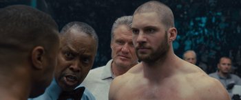 Movie still from “Creed II” (2018), directed by Steven Caple Jr. – A group of men standing next to each other; Close Up shot, Over the shoulder angle