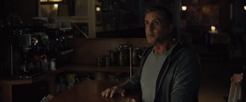 Movie still from “Creed II” (2018), directed by Steven Caple Jr. – A man sitting at a table in front of pots and pans; Close Up shot, Over the shoulder angle