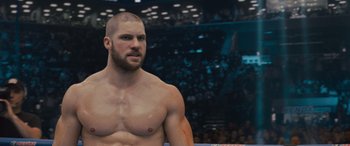 Movie still from “Creed II” (2018), directed by Steven Caple Jr. – A man that is standing up in the ring; Close Up shot, Over the shoulder angle