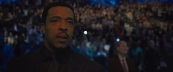 Movie still from “Creed II” (2018), directed by Steven Caple Jr. – A person wearing a suit and tie; Close Up shot, Low angle