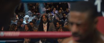 Movie still from “Creed II” (2018), directed by Steven Caple Jr. – A crowd of people sitting in a boxing ring; Medium shot, High angle