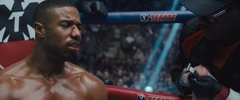 Movie still from “Creed II” (2018), directed by Steven Caple Jr. – A person in a boxing ring; Close Up shot, Over the shoulder angle