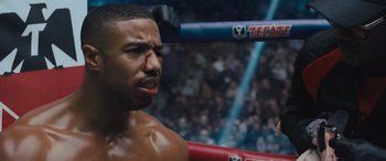 Movie still from “Creed II” (2018), directed by Steven Caple Jr. – A person in a boxing ring; Close Up shot, Over the shoulder angle