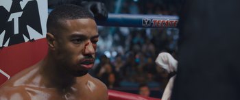 Movie still from “Creed II” (2018), directed by Steven Caple Jr. – A person in a boxing ring; Close Up shot, Over the shoulder angle