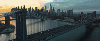 Movie still from “Creed II” (2018), directed by Steven Caple Jr. – A view of a bridge and a city skyline at sunset; Extreme Wide shot, High angle