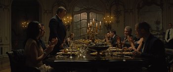 Movie still from “Creed II” (2018), directed by Steven Caple Jr. – A group of people sitting around a dinner table; Wide shot, High angle